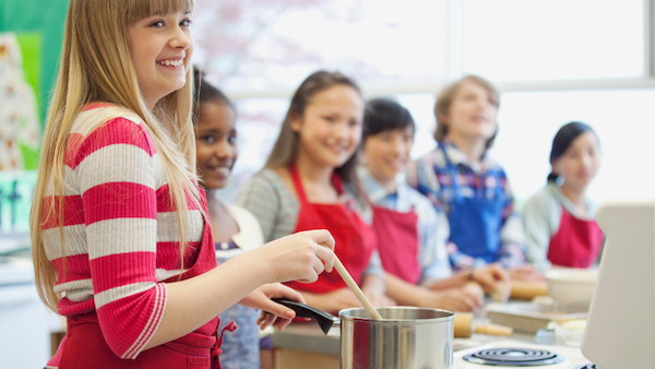 Students cooking during a food tech workshop lesson